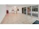 Open living space with access to the kitchen and patio at 660 Saxon Blvd, Deltona, FL 32725