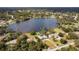 Aerial view of home on a lake with surrounding houses at 660 Saxon Blvd, Deltona, FL 32725