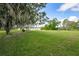 Spacious backyard with mature trees and lake view at 660 Saxon Blvd, Deltona, FL 32725