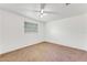 Simple bedroom with neutral colored carpet and ceiling fan at 660 Saxon Blvd, Deltona, FL 32725