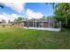 Brick home exterior, screened porch and lush lawn at 660 Saxon Blvd, Deltona, FL 32725