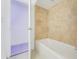 Bathroom with beige tile and a bathtub at 660 Saxon Blvd, Deltona, FL 32725