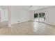 Spacious living room featuring tile floors and sliding glass doors leading outside at 660 Saxon Blvd, Deltona, FL 32725