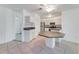 Kitchen with an octagonal island and white cabinets at 660 Saxon Blvd, Deltona, FL 32725