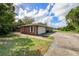 Brick house exterior showcasing a garage and walkway, offering curb appeal at 660 Saxon Blvd, Deltona, FL 32725