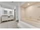 Clean bathroom with double vanity, tiled shower and bathtub at 660 Saxon Blvd, Deltona, FL 32725