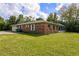 Brick home's exterior showcasing a garage and landscaped yard at 660 Saxon Blvd, Deltona, FL 32725