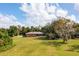 Backyard view of single-story home with large lawn at 660 Saxon Blvd, Deltona, FL 32725