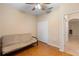 Bedroom with wood floors, neutral walls, and a futon at 966 Springs Landing Dr, Deltona, FL 32725