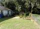 Large backyard with mature trees and a shed at 950 S Parsons Ave, Deland, FL 32720
