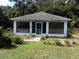 Cute one-story house with a screened porch at 950 S Parsons Ave, Deland, FL 32720
