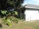 Back of house with mature landscaping and shed at 950 S Parsons Ave, Deland, FL 32720