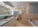 Updated bathroom with granite countertops, a soaking tub, and a walk-in shower at 1020 Hanford Dr, Deltona, FL 32738
