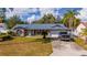 One-story home with blue roof, attached garage, and spacious yard at 1020 Hanford Dr, Deltona, FL 32738