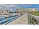 Wooden boardwalk leads to waterfront community with boat slips and resort-style building at 4650 Links Village Dr # C303, Ponce Inlet, FL 32127