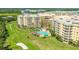 Aerial view of building with pool and golf course at 4650 Links Village Dr # C303, Ponce Inlet, FL 32127