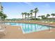 Another view of the community pool and chairs at 4650 Links Village Dr # C303, Ponce Inlet, FL 32127