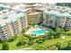 Aerial view of building with pool and green space at 4650 Links Village Dr # C303, Ponce Inlet, FL 32127