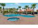 Community pool and spa area with lounge chairs and building in background at 4650 Links Village Dr # C303, Ponce Inlet, FL 32127