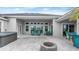 Spacious covered patio with seating area, fire pit, and hot tub at 53 Marden Dr, Ormond Beach, FL 32176
