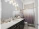 Bathroom with dark vanity, quartz countertop, and shower/tub combo at 53 Marden Dr, Ormond Beach, FL 32176