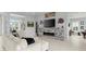 Open living room showcasing a sectional sofa, fireplace, and views into the kitchen and game room at 53 Marden Dr, Ormond Beach, FL 32176