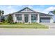 Two-story house featuring a gray facade, white columns, and a teal porch at 53 Marden Dr, Ormond Beach, FL 32176