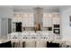 Modern kitchen with white cabinets, stainless steel appliances, and large island at 53 Marden Dr, Ormond Beach, FL 32176