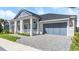 Two-story home with gray siding, a large garage, and a landscaped yard at 53 Marden Dr, Ormond Beach, FL 32176