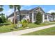 Gray two-story house with white columns, landscaping, and a grassy yard at 53 Marden Dr, Ormond Beach, FL 32176