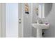 Small bathroom with pedestal sink and frosted glass door at 53 Marden Dr, Ormond Beach, FL 32176