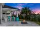 Outdoor kitchen with seating and a fire pit, perfect for entertaining at 53 Marden Dr, Ormond Beach, FL 32176