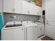 Bright laundry room with white cabinets, Samsung washer and dryer, and ample storage at 53 Marden Dr, Ormond Beach, FL 32176