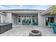 Spacious covered patio with seating area, fire pit, and hot tub at 53 Marden Dr, Ormond Beach, FL 32176