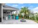 Outdoor kitchen with grill and bar seating at 53 Marden Dr, Ormond Beach, FL 32176