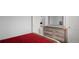 Bedroom with dresser and red bedspread at 53 Marden Dr, Ormond Beach, FL 32176