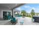 Outdoor patio with seating, fire pit, hot tub, and grilling station at 53 Marden Dr, Ormond Beach, FL 32176