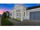 Two-story home with front porch, gray siding, and a two-car garage at 53 Marden Dr, Ormond Beach, FL 32176