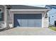 Attached two-car garage with gray doors at 53 Marden Dr, Ormond Beach, FL 32176