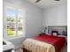 Bright bedroom with a comfortable bed and plantation shutters at 53 Marden Dr, Ormond Beach, FL 32176