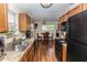 Galley kitchen with stainless steel appliances and wood cabinets at 1230 8Th Ave, Deland, FL 32724