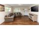 Living room with brown leather sectional sofa and wood flooring at 1230 8Th Ave, Deland, FL 32724