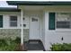Charming home exterior with white door and green shutters at 201 N Hill Ave # 150, Deland, FL 32724