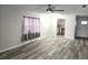 Open living room with vinyl plank flooring, view of kitchen, and neutral walls at 201 N Hill Ave # 150, Deland, FL 32724
