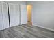Spacious bedroom with gray vinyl plank flooring and double door closet at 201 N Hill Ave # 150, Deland, FL 32724