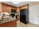 Kitchen with dark wood cabinets and black appliances at 450 Tradition Ln, Winter Springs, FL 32708