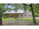 House exterior with a wraparound porch and landscaping at 5711 John Anderson Hwy, Flagler Beach, FL 32136
