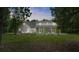 House back view with screened porch and fenced backyard at 5711 John Anderson Hwy, Flagler Beach, FL 32136