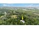Aerial view of house near water, surrounded by trees at 5711 John Anderson Hwy, Flagler Beach, FL 32136