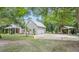 House exterior showcasing a large yard and double garage at 5711 John Anderson Hwy, Flagler Beach, FL 32136